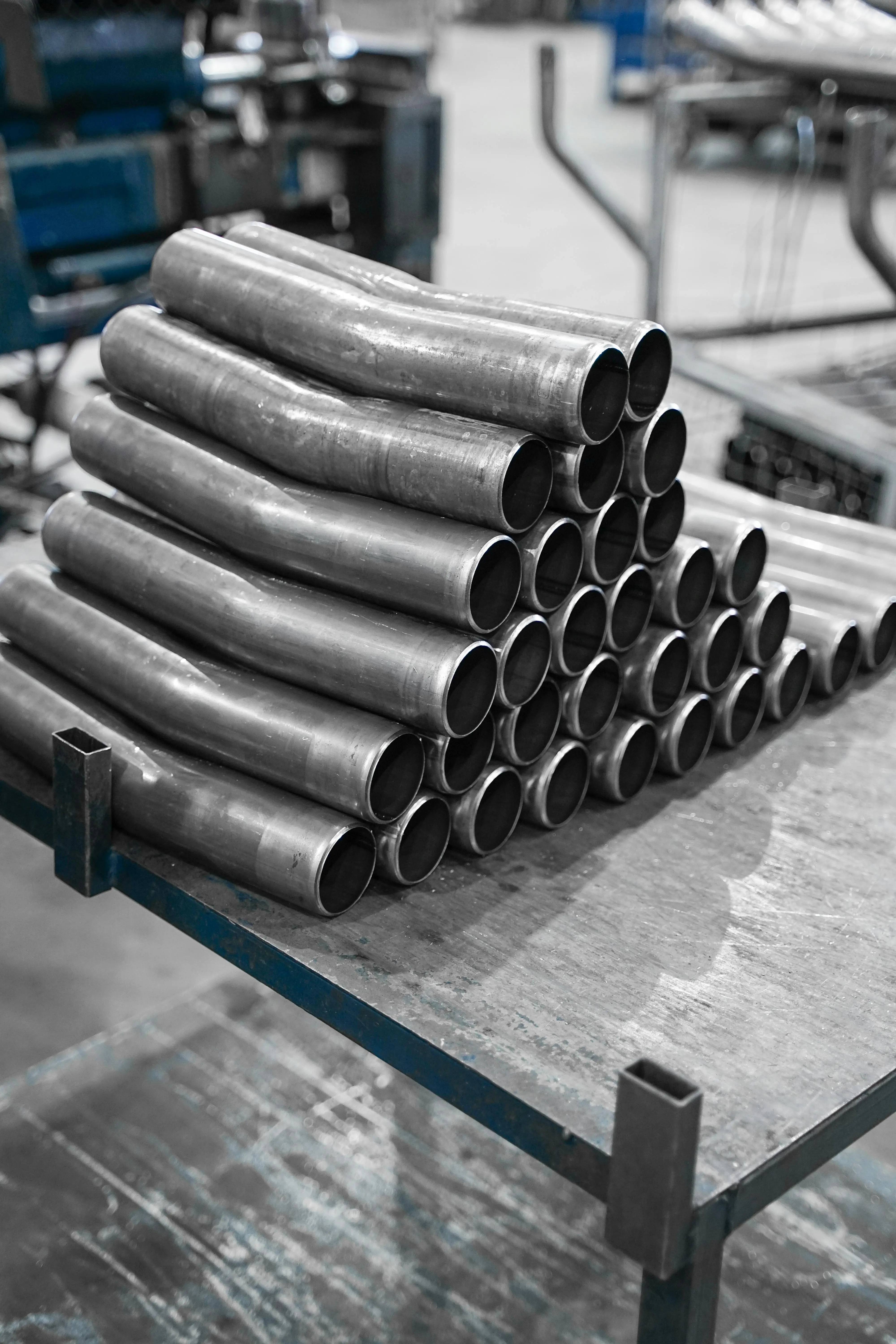 Stacked bent metal tubes ready for assembly